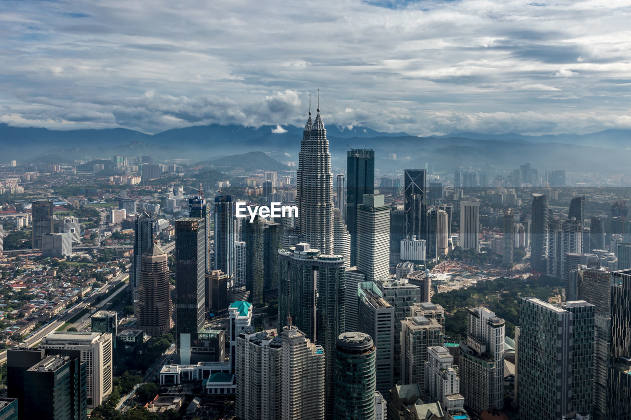 High angle view of modern buildings in city against sky