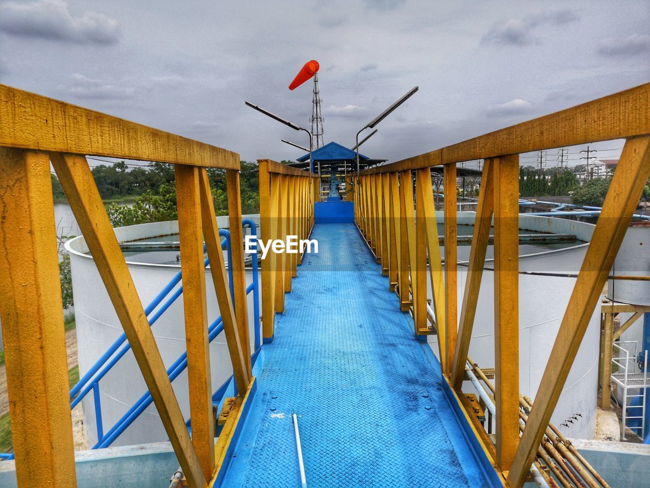 Empty footbridge against sky