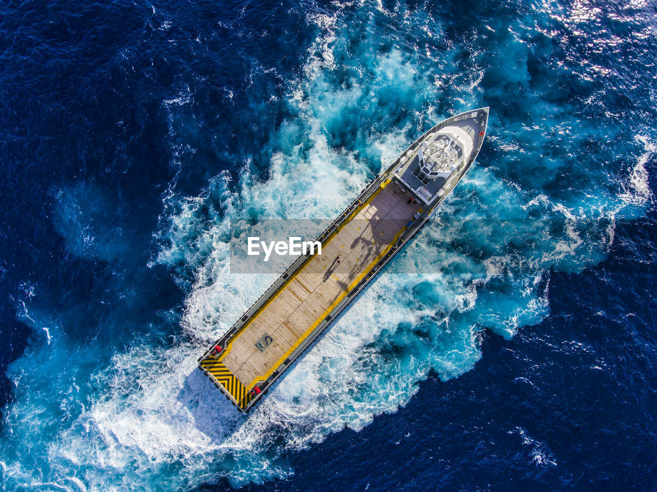 High angle view of container ship sailing in sea