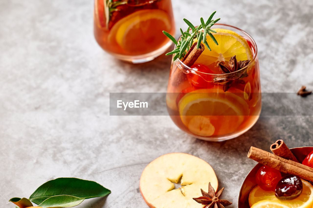 Mulled wine or christmas sangria with aromatic spices, apple, cherry and citrus fruits.