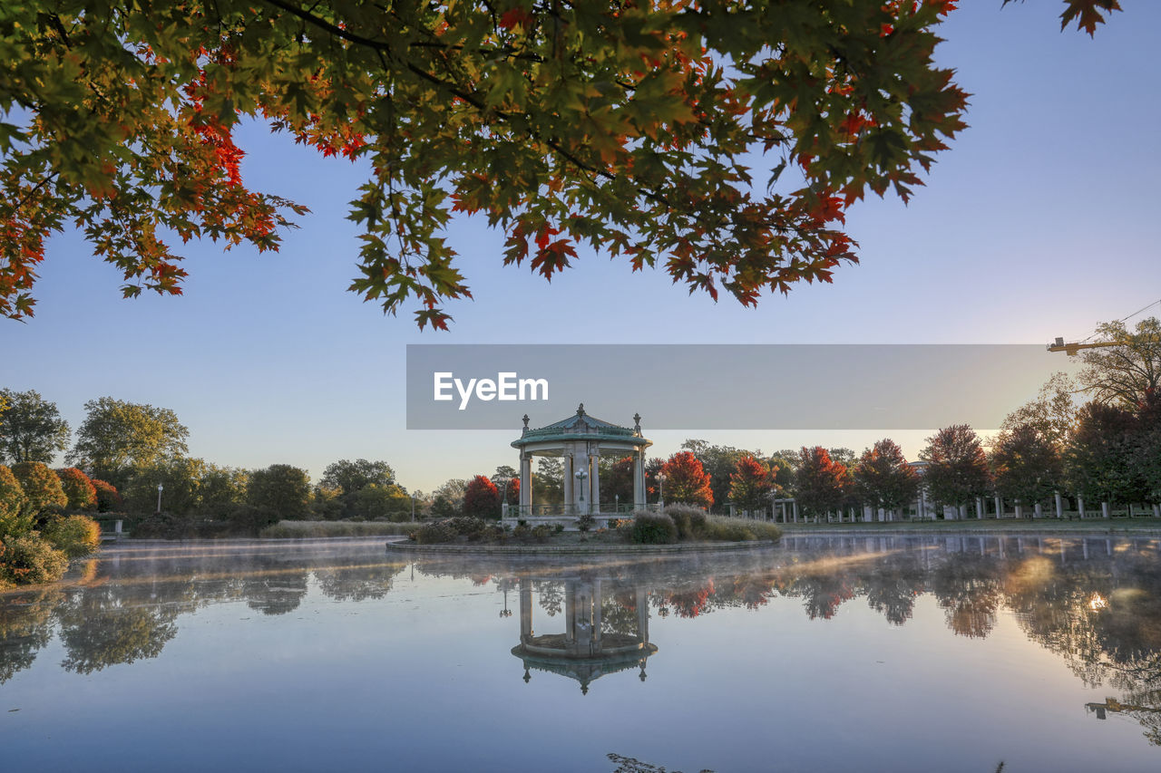 SCENIC VIEW OF LAKE BY BUILDINGS AGAINST SKY