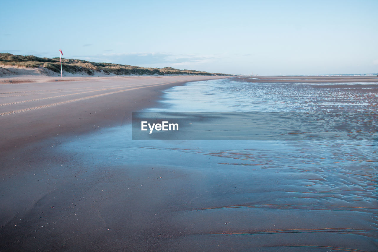 Scenic view of beach against clear sky