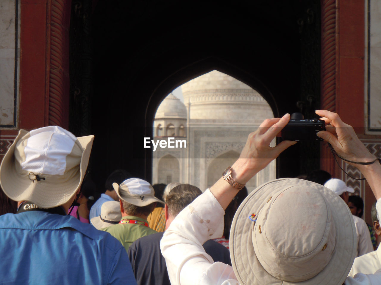 Group of people clicking photo of taj mahal