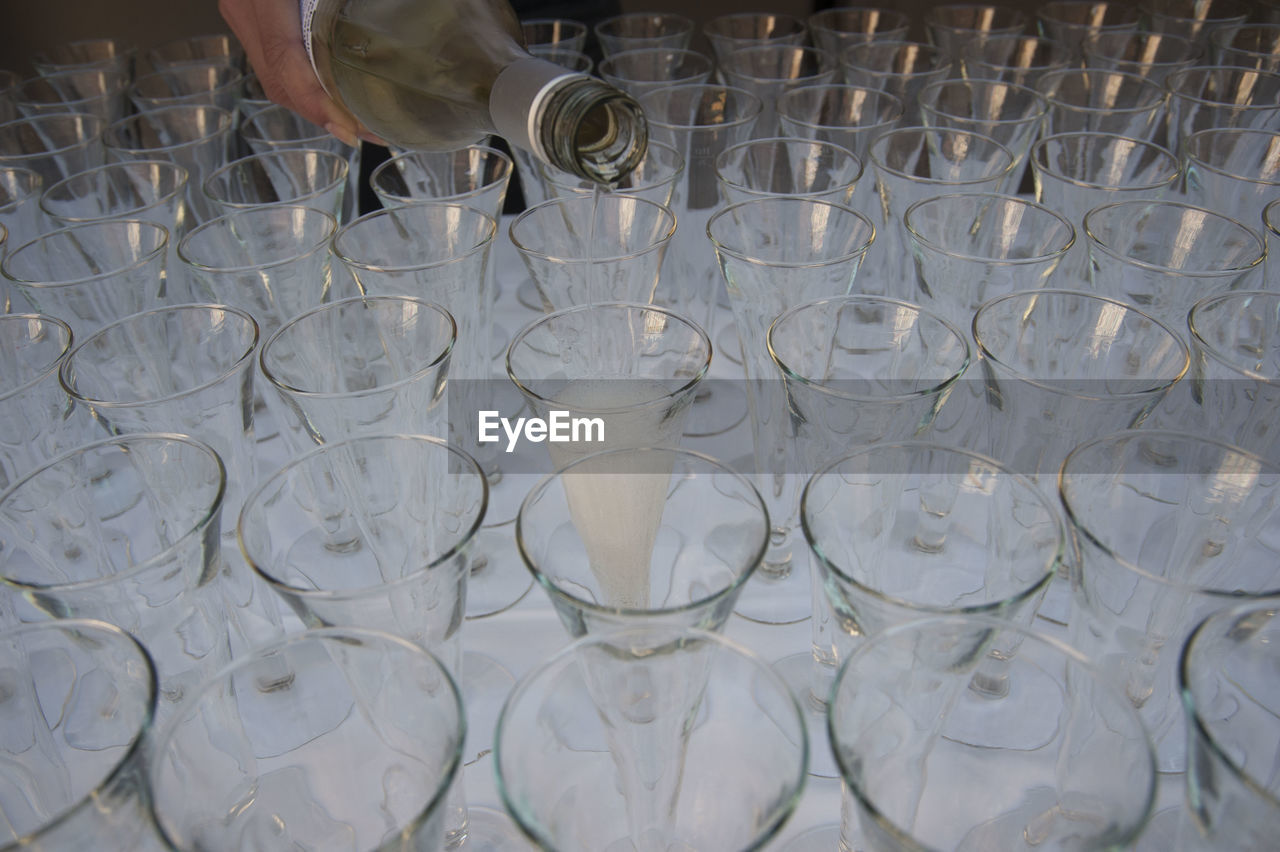 Pouring champagne into champagne glasses, alcoholic beverage for festive occasions