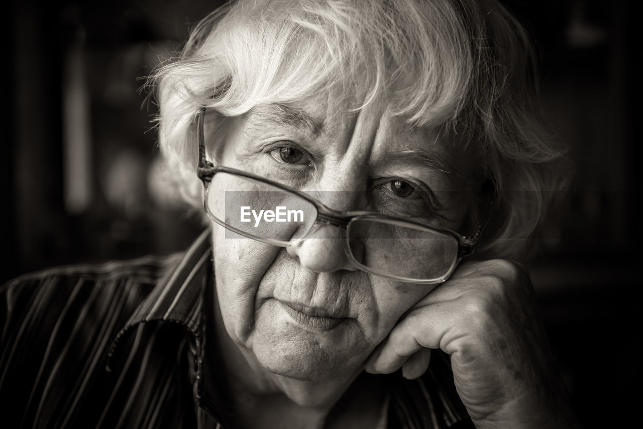 Close-up portrait of senior woman wearing eyeglasses