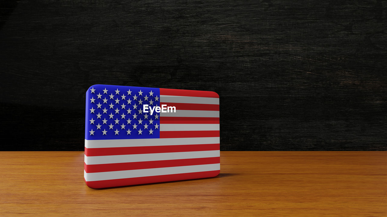 CLOSE-UP OF FLAG ON BLUE TABLE