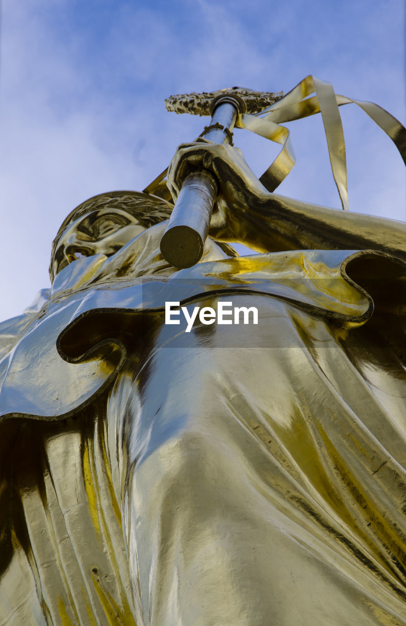 Low angle view of statue at victory column against sky in city