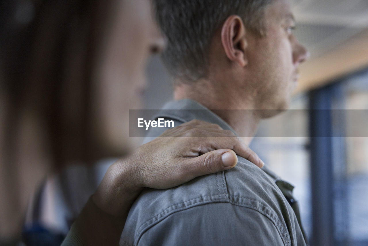 Mature woman touching man's arm