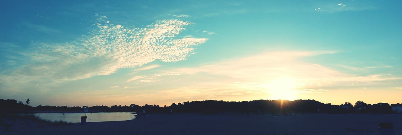 Panoramic view of beach against sky during sunset