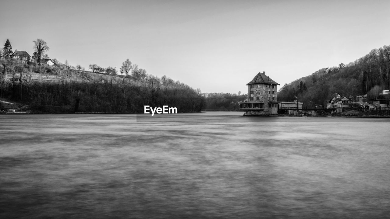 Lake and buildings against sky