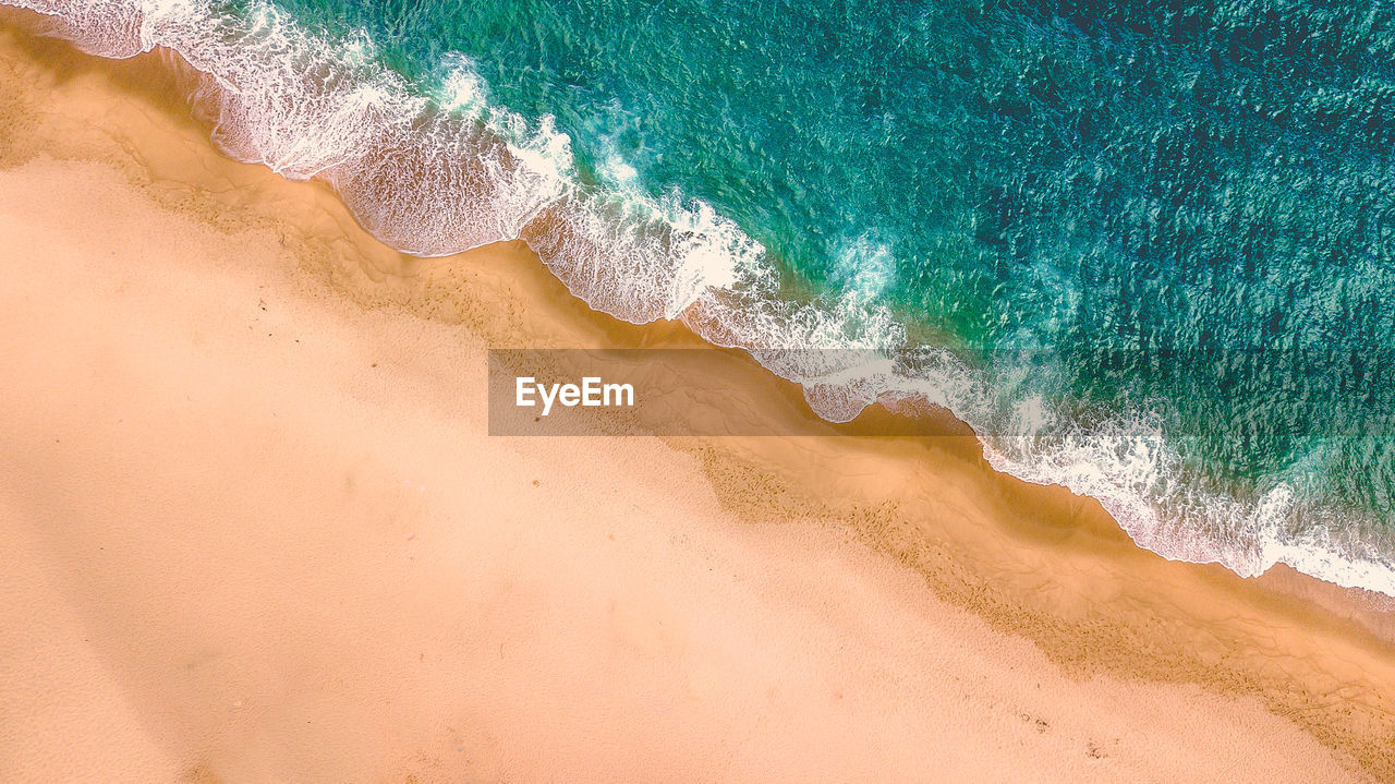 land, water, sea, beach, sand, wave, green, water sports, wind wave, surfing, sports, nature, beauty in nature, scenics - nature, motion, day, tranquility, high angle view, environment, turquoise, outdoors, ocean, azure, travel destinations, travel, body of water, aerial view, aqua, holiday, landscape, blue, shore, vacation, backgrounds, trip, tranquil scene, idyllic, summer, coastline