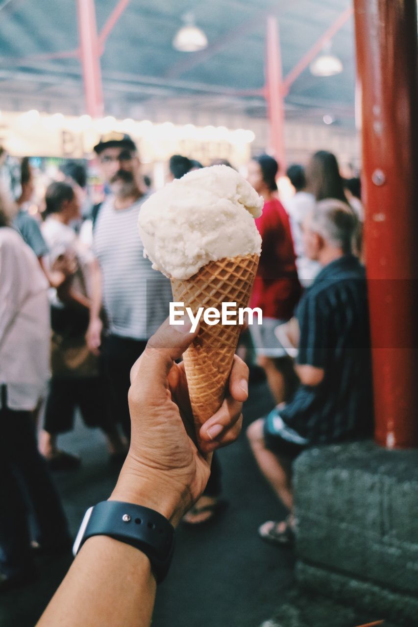 Cropped hand holding ice cream