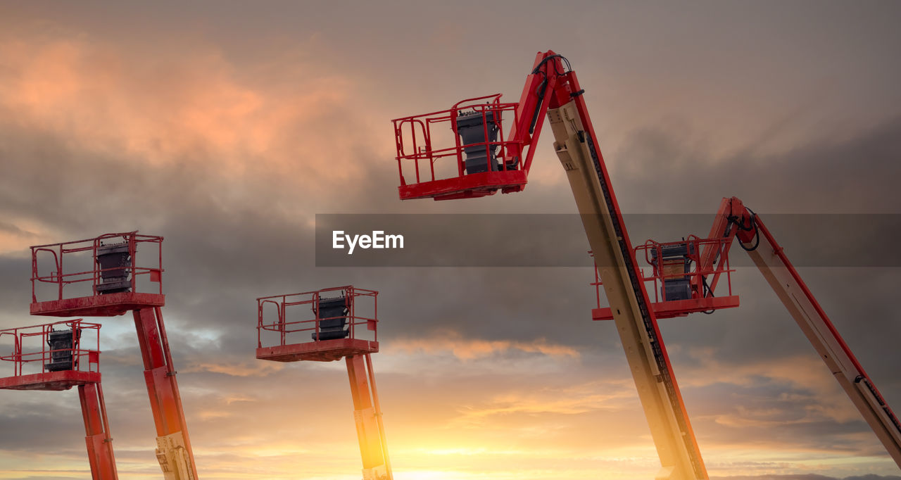 Articulated boom lift. aerial platform lift. telescopic boom lift with sunset sky. mobile crane.