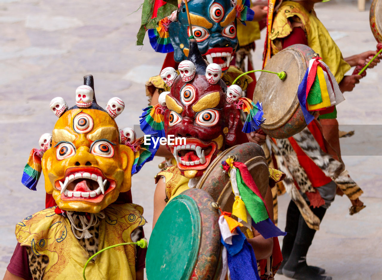 LOW ANGLE VIEW OF MULTI COLORED SCULPTURE IN TRADITIONAL CLOTHING