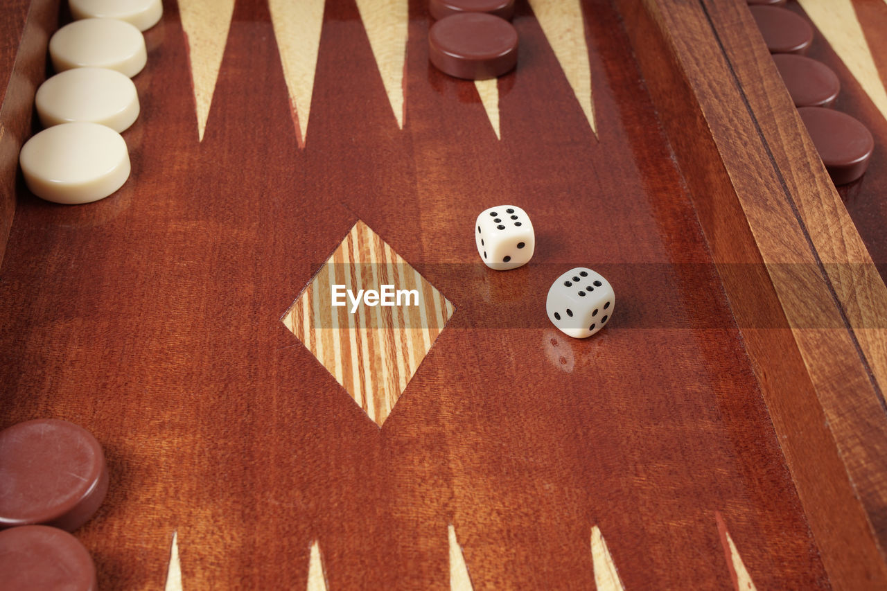 Close-up of rolling dices on wooden table