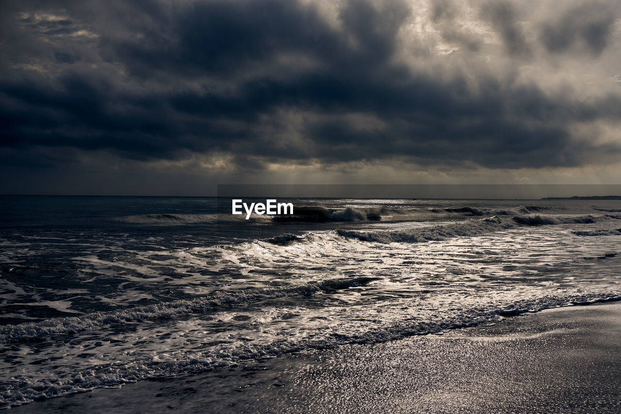 Scenic view of sea against cloudy sky