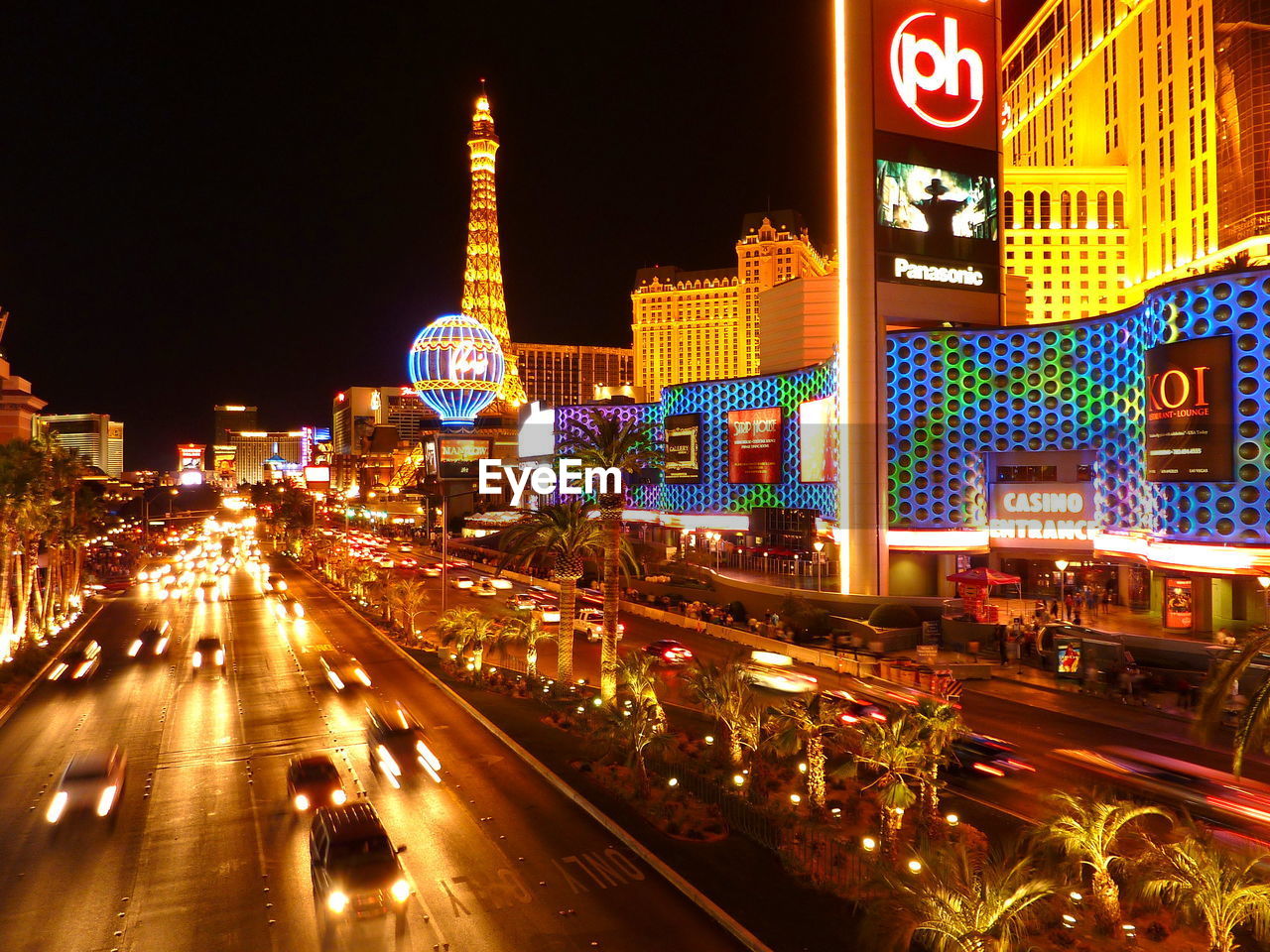 ILLUMINATED CITY STREET AND BUILDINGS AT NIGHT