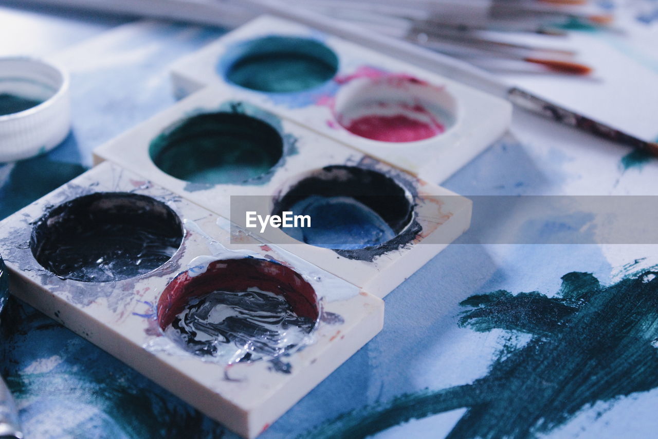 Close-up of messy palette on table