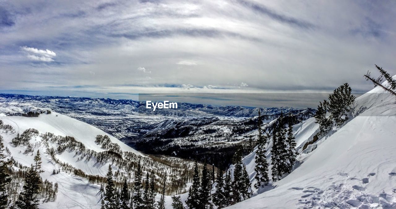 Scenic view of snow covered mountains against sky