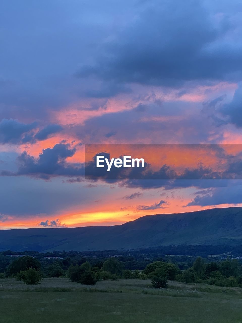 SCENIC VIEW OF LANDSCAPE AGAINST ORANGE SKY