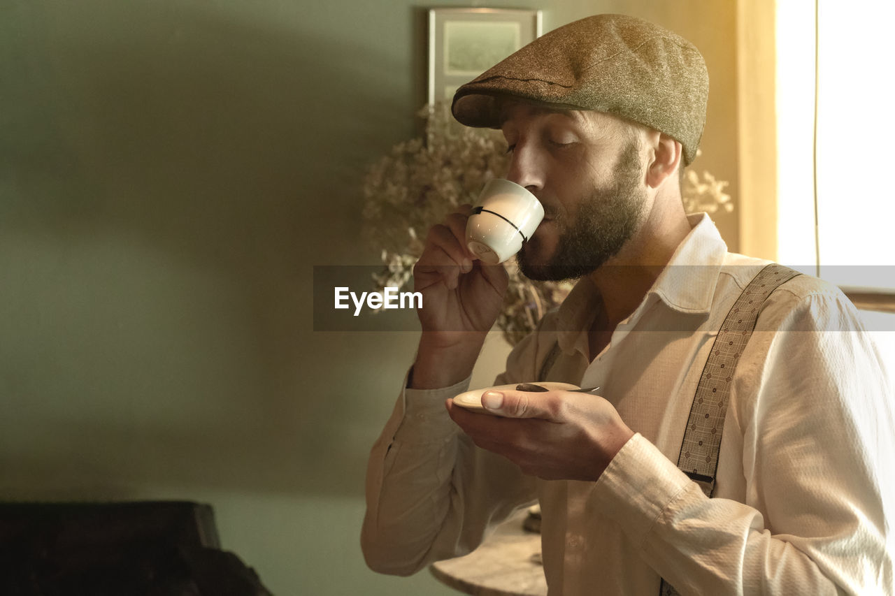 Man drinking coffee at home