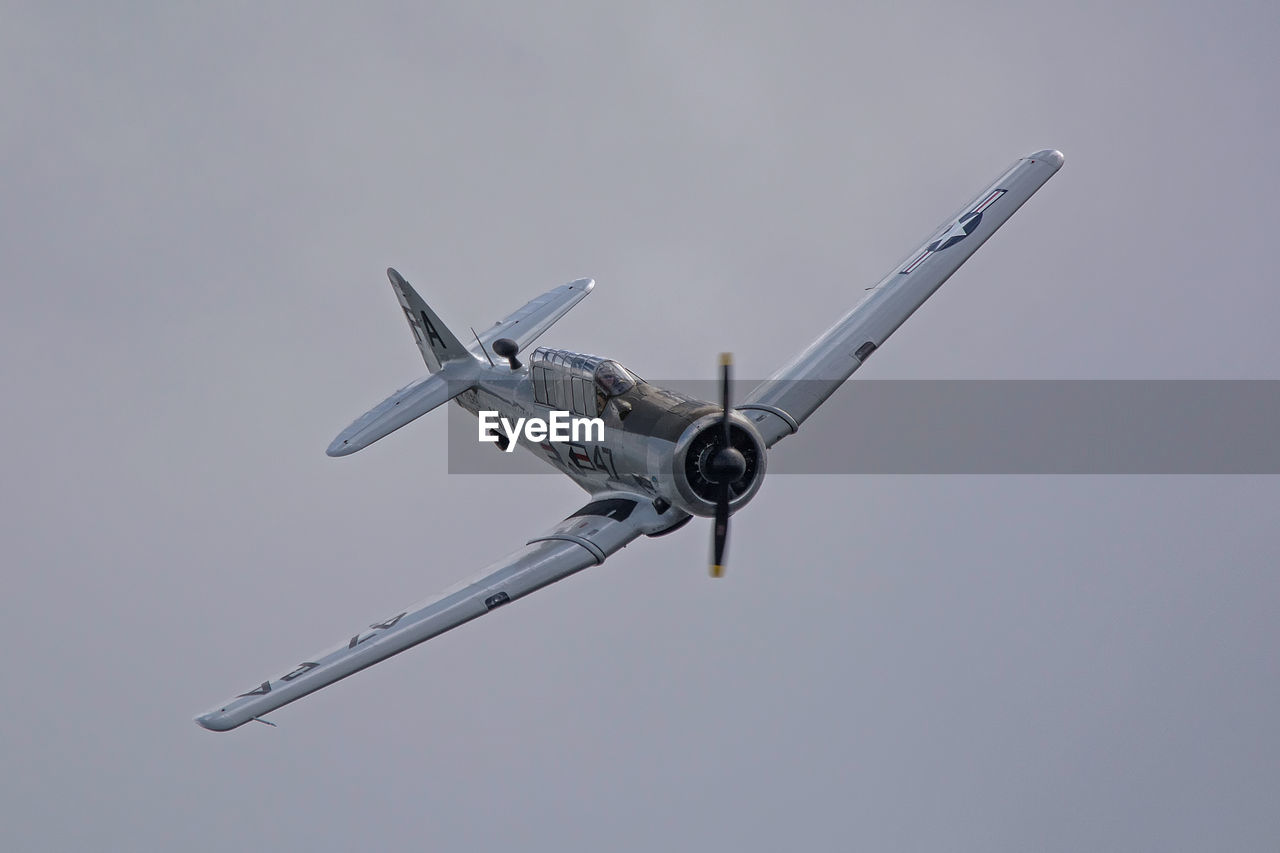 flying, transportation, airplane, air vehicle, clear sky, mode of transport, mid-air, low angle view, outdoors, day, no people, sky