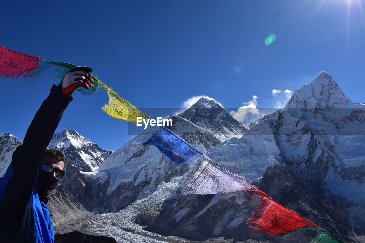 Man touching prayer flag during winter