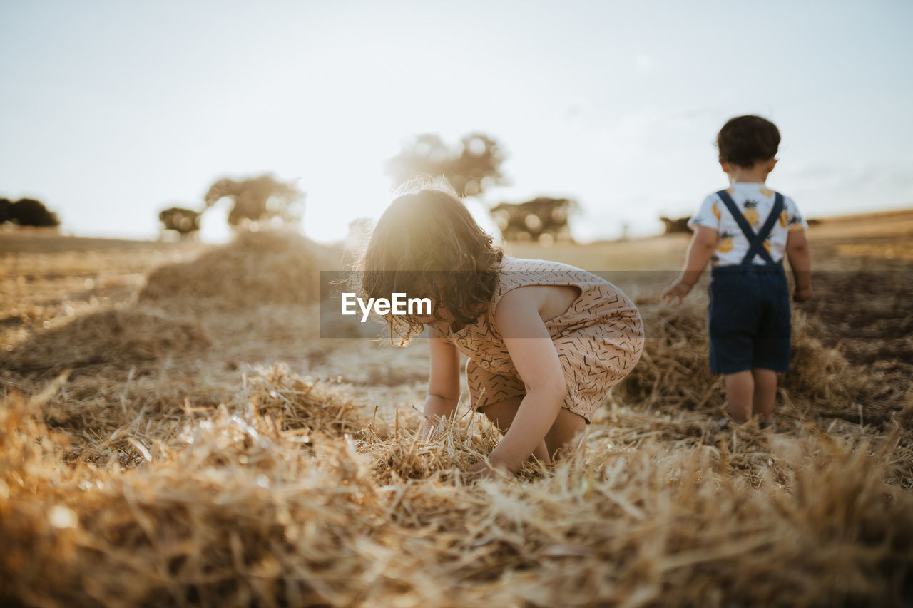 Brother and sister playing in the fields