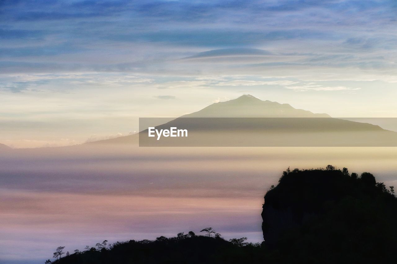 Scenic view of mountain against sky at sunset