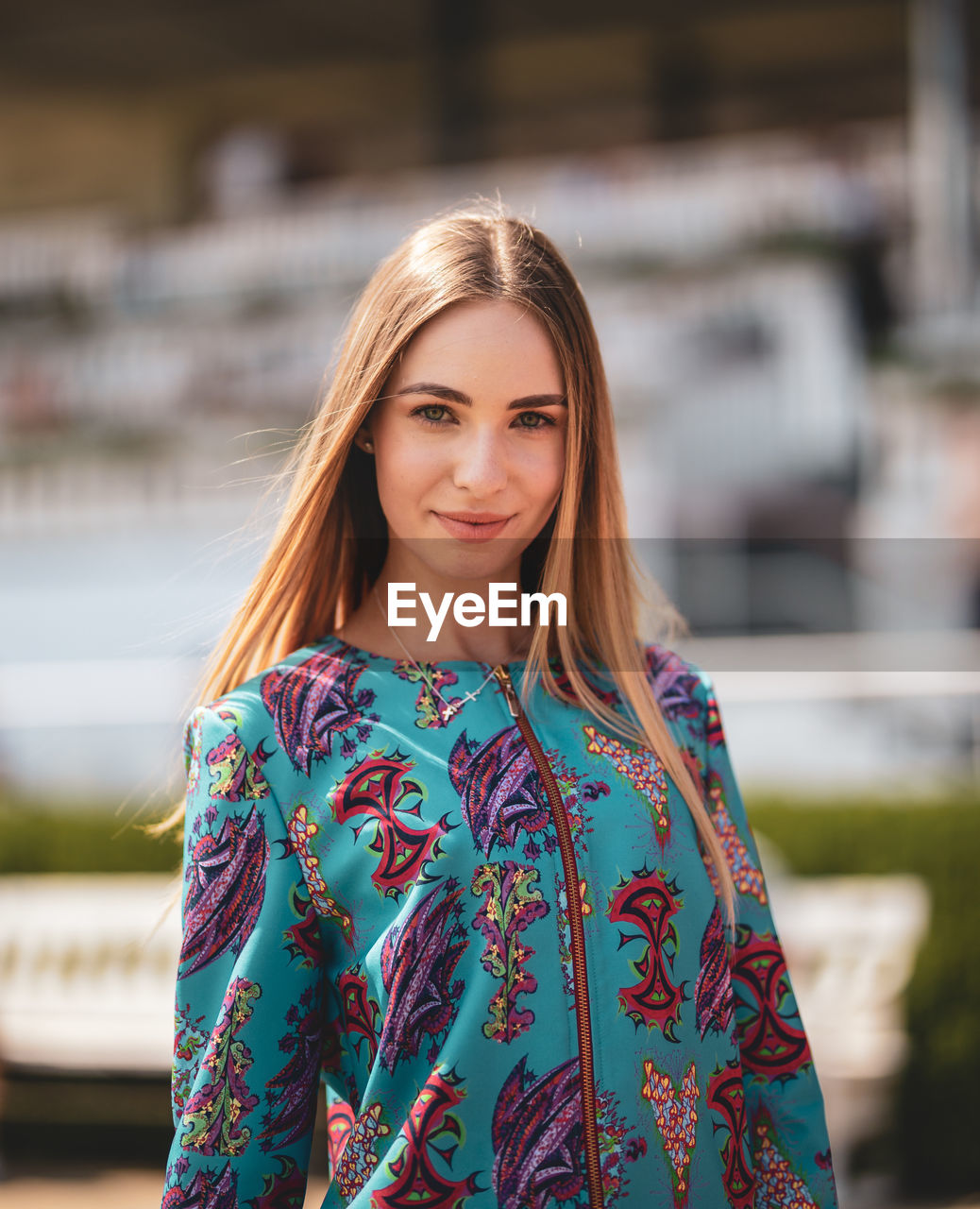 Portrait of smiling young woman standing outdoors