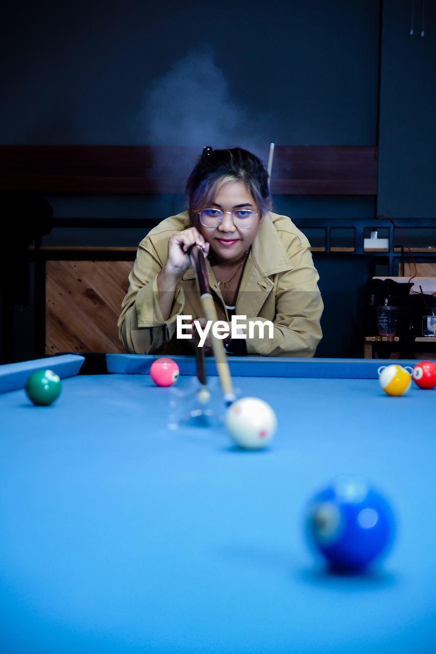 midsection of woman playing pool