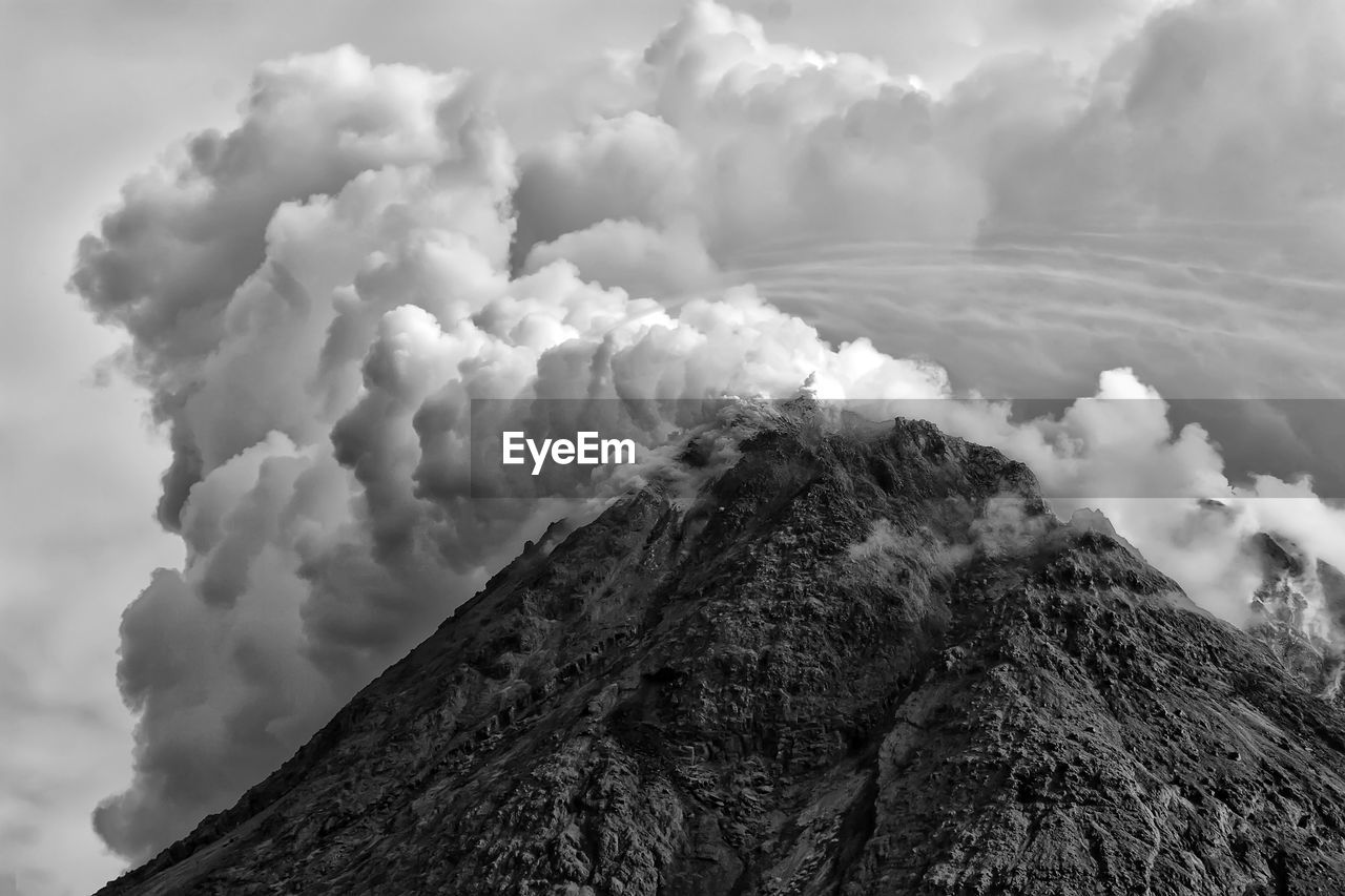 Low angle view of volcanic mountain against sky