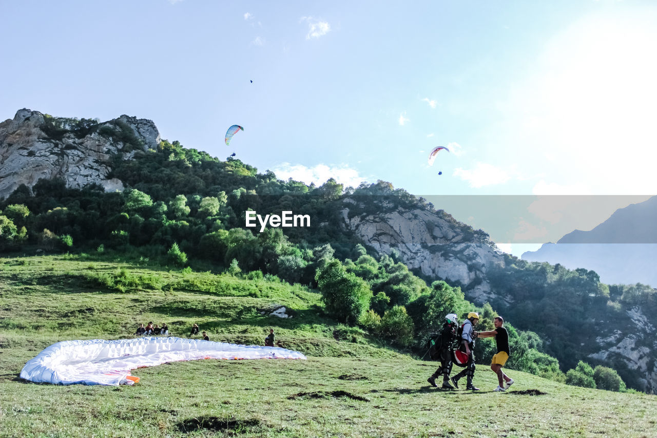 People paragliding on mountain