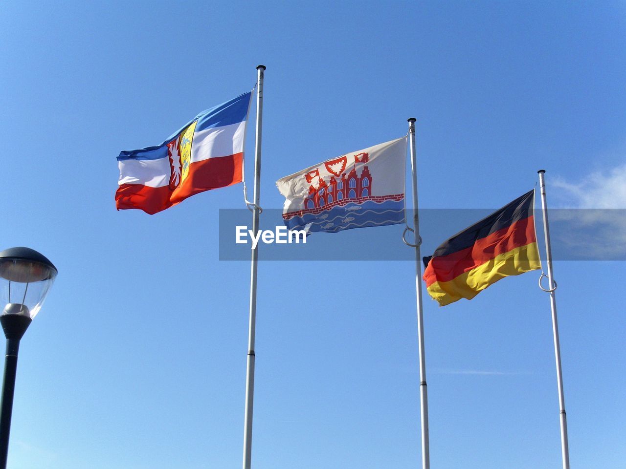 LOW ANGLE VIEW OF FLAG FLAGS AGAINST BLUE SKY