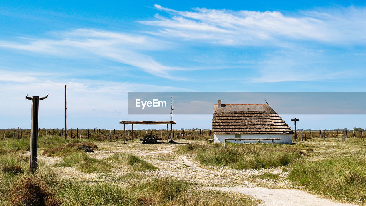 Camarguaise cabin on field against sky