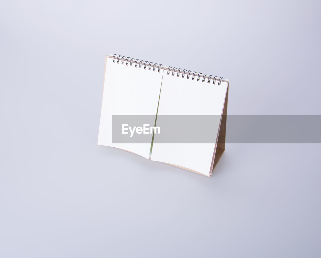 High angle view of blank desk calendar over white background