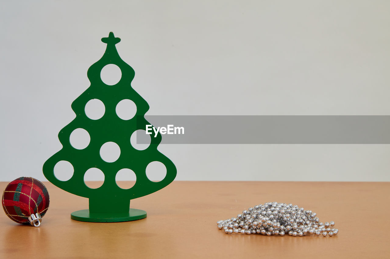 christmas tree, christmas decoration, no people, christmas, decoration, indoors, tree, holiday, green, celebration, shape, plant, copy space, studio shot, nature, wood, table, still life