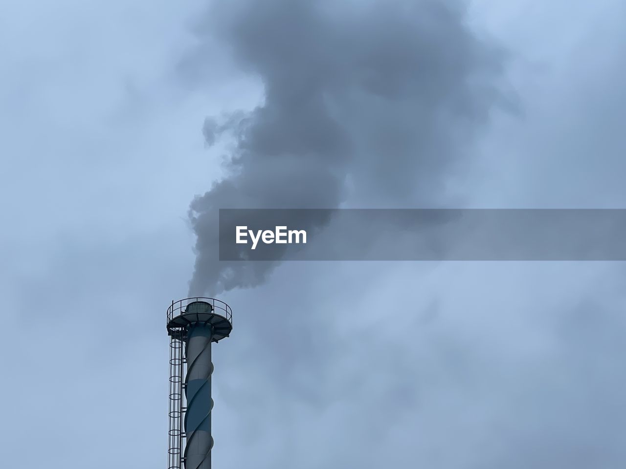 LOW ANGLE VIEW OF SMOKE STACK AGAINST CLOUDY SKY