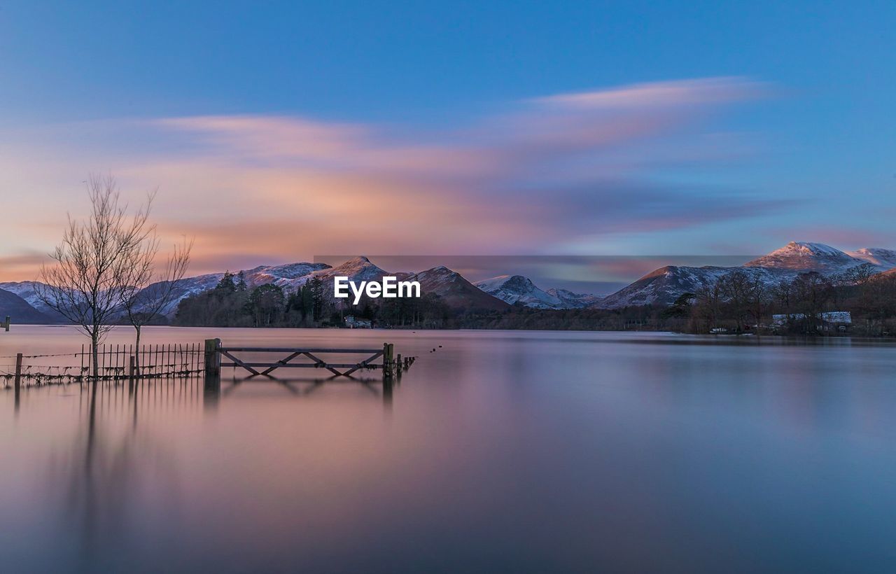 SCENIC VIEW OF FROZEN LAKE AGAINST SKY