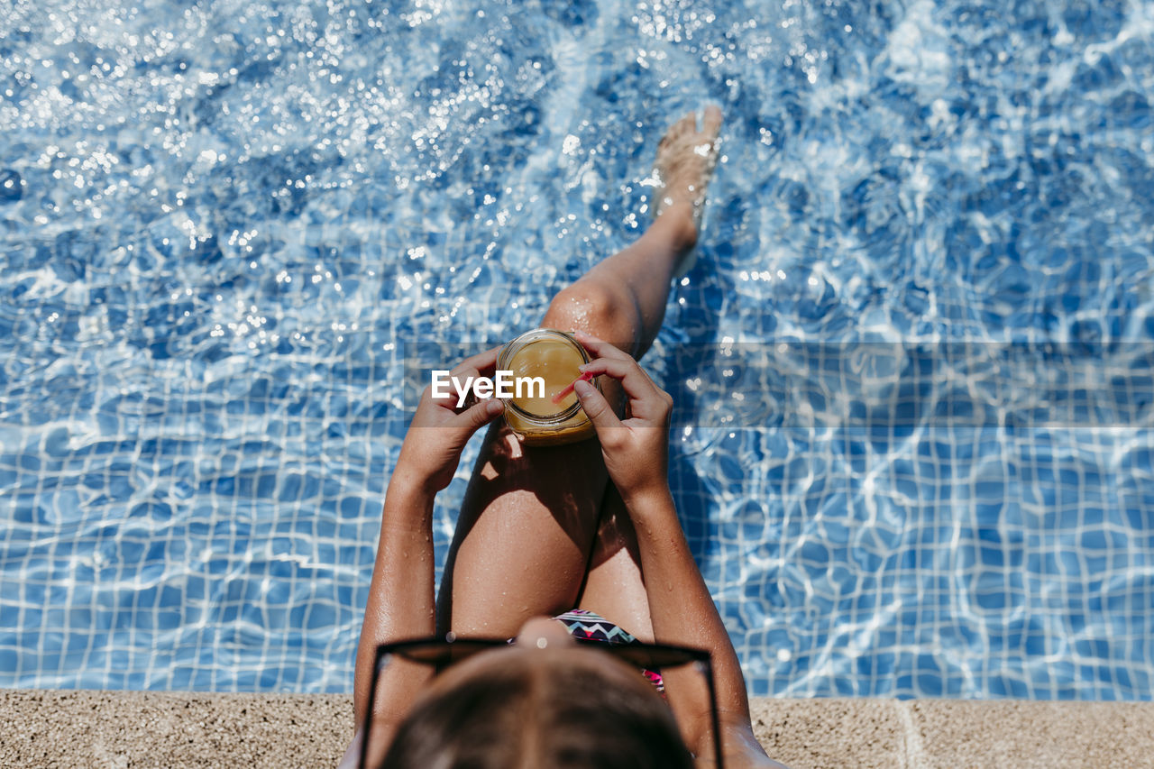 LOW SECTION OF MAN RELAXING IN WATER