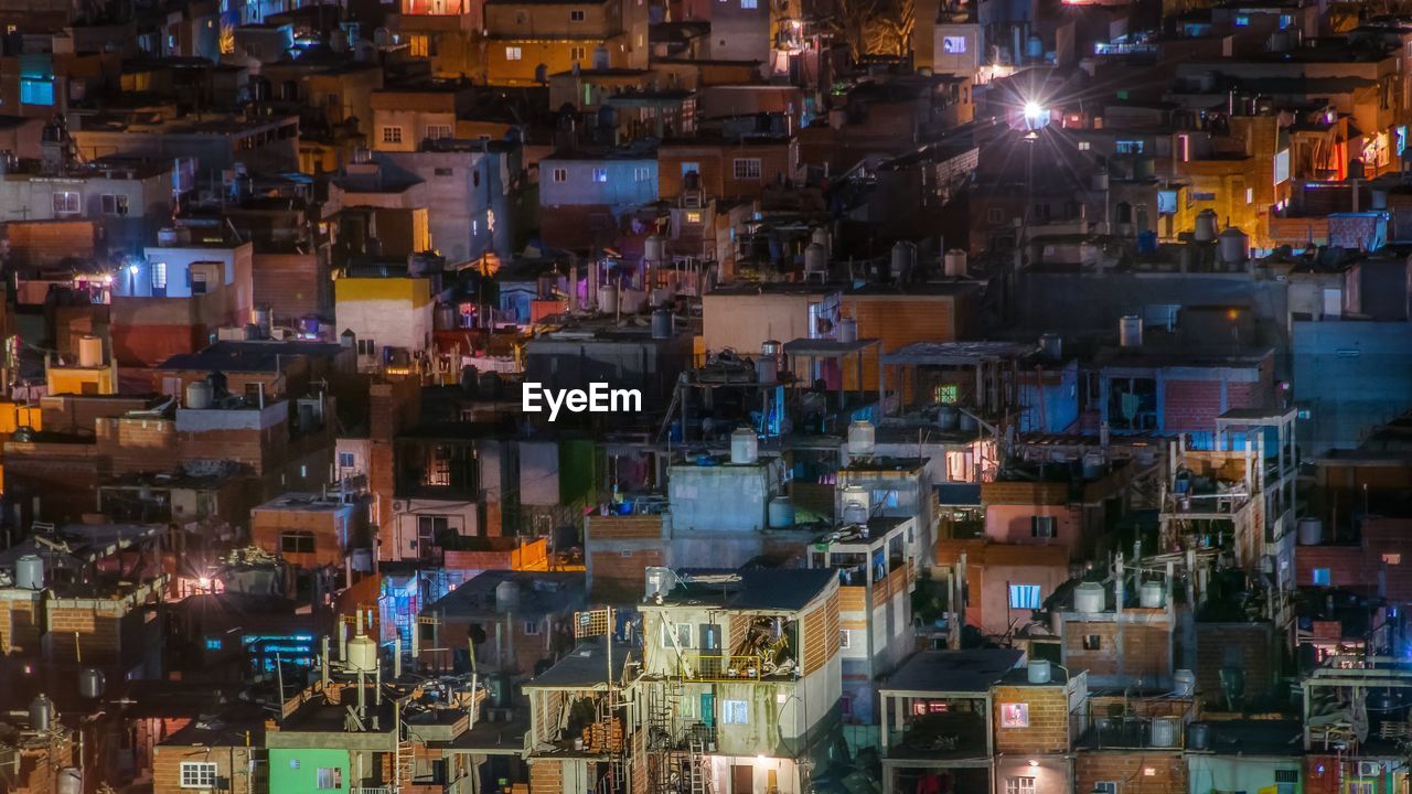 High angle view of illuminated buildings in townscape at night