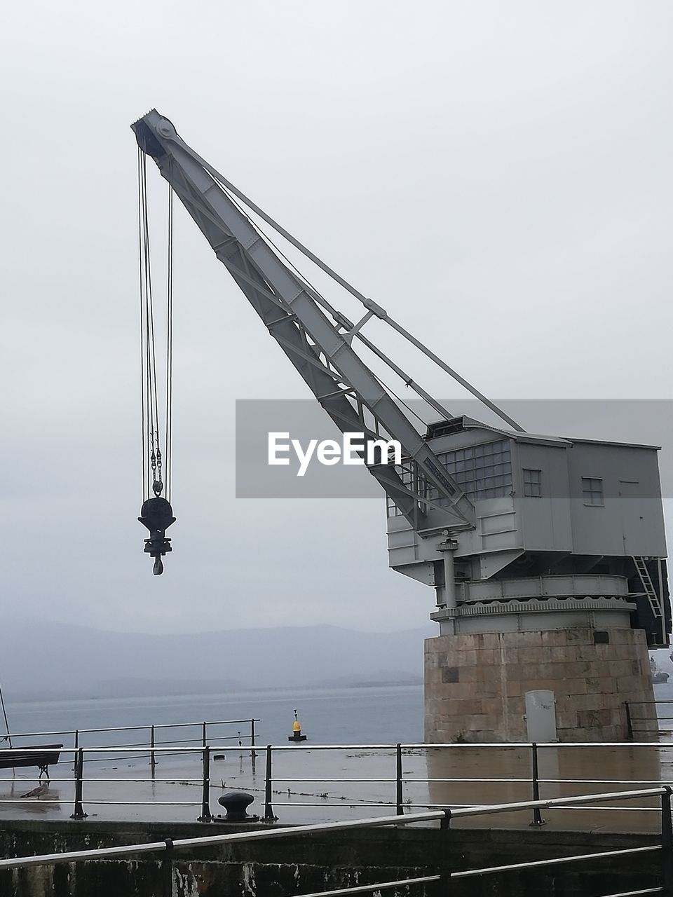 LOW ANGLE VIEW OF CRANE AT CONSTRUCTION SITE