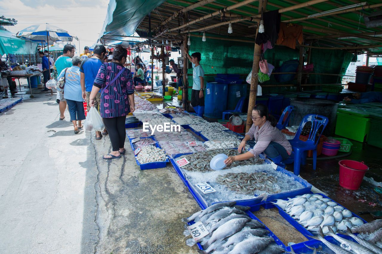 PEOPLE IN MARKET STALL