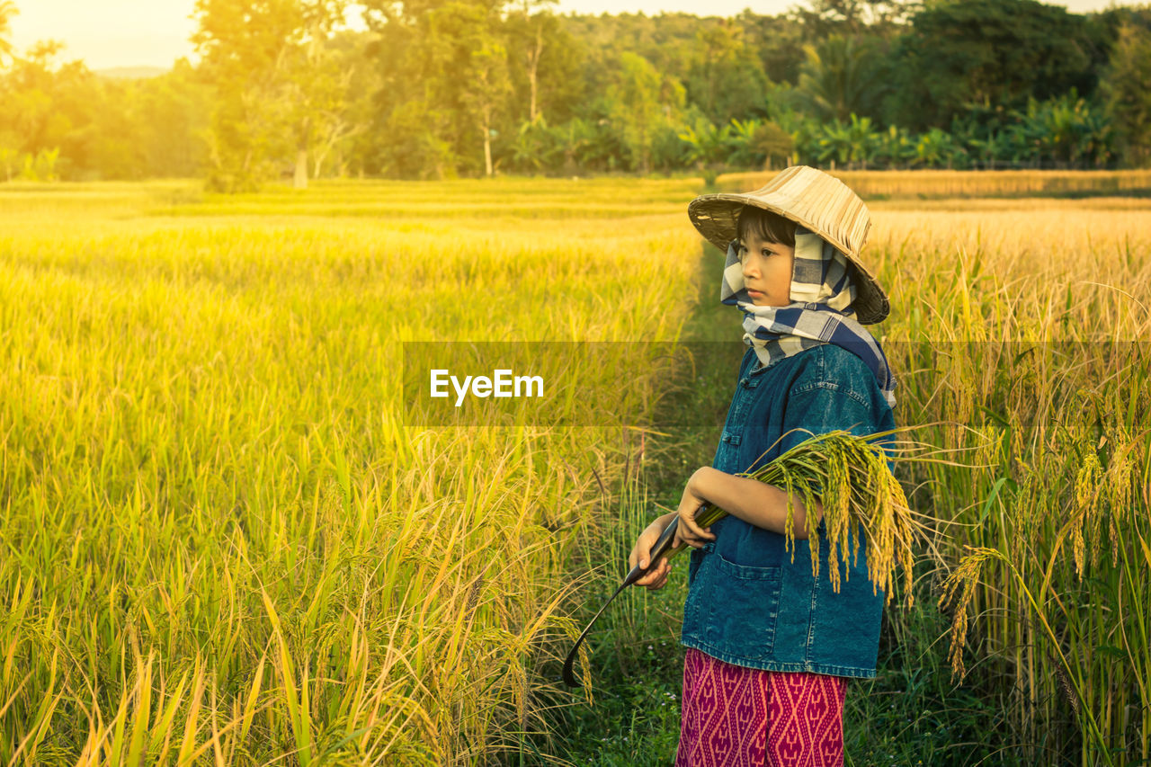 Girl standing on rice field