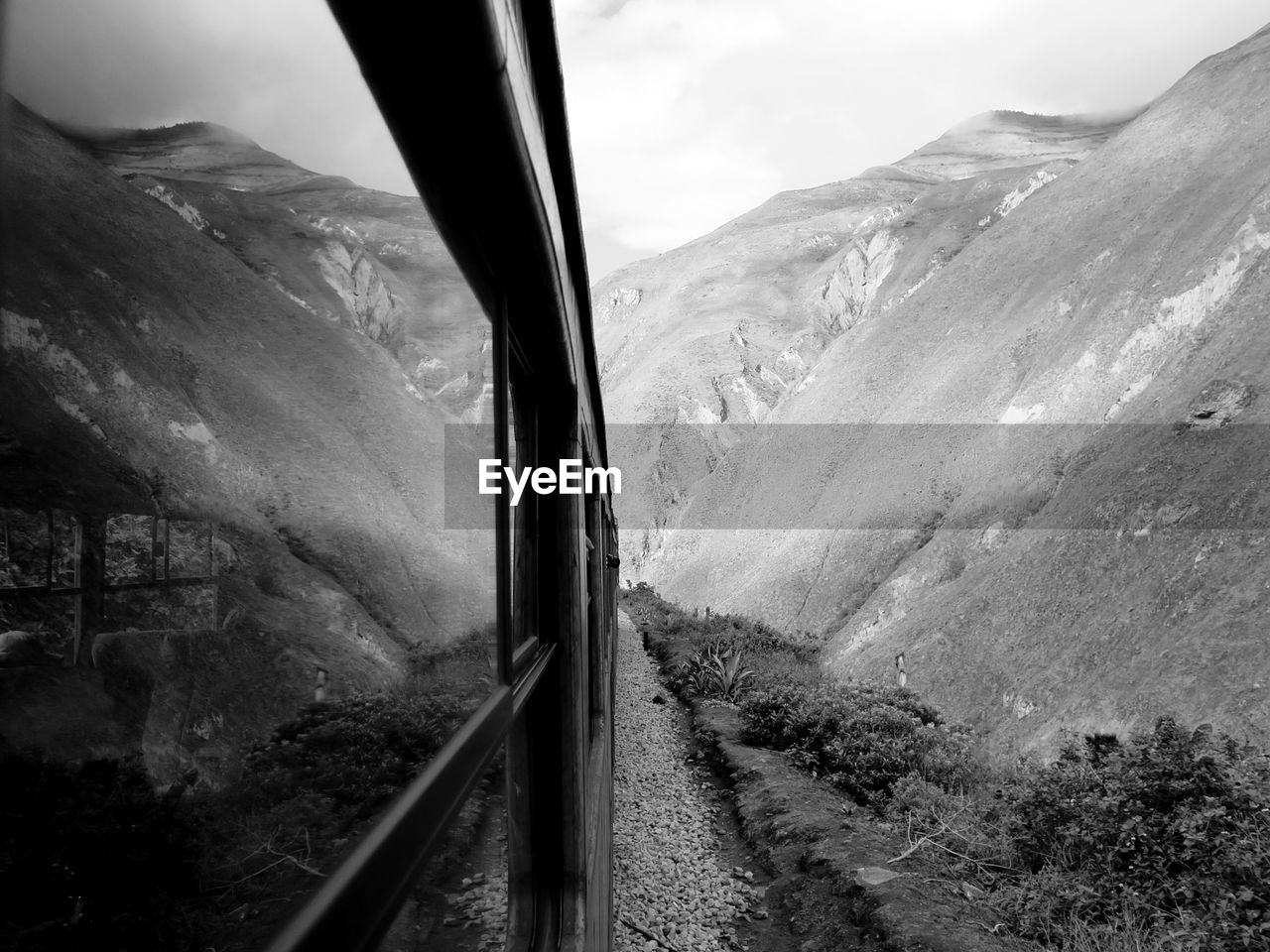 Reflection of mountains on train window