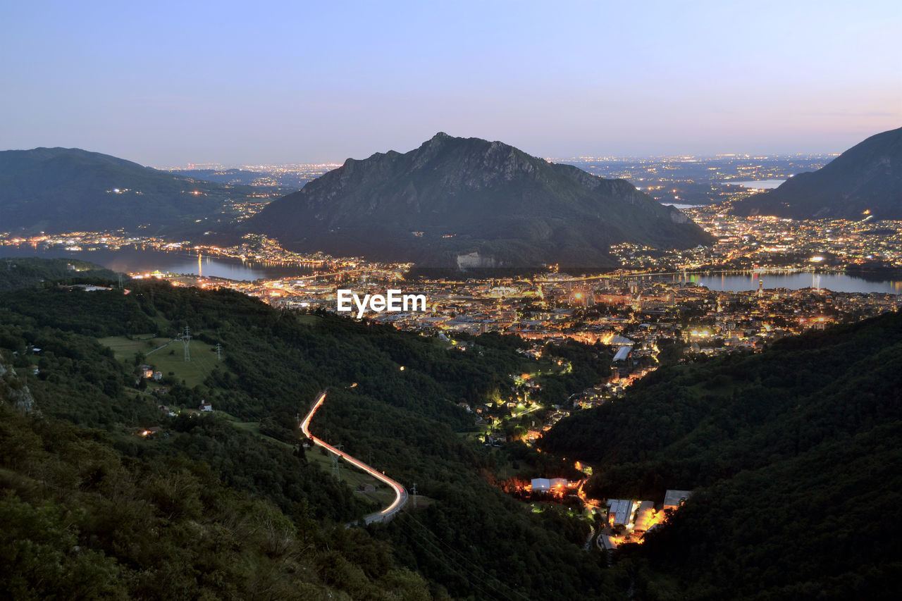 HIGH ANGLE VIEW OF ILLUMINATED BUILDINGS IN CITY