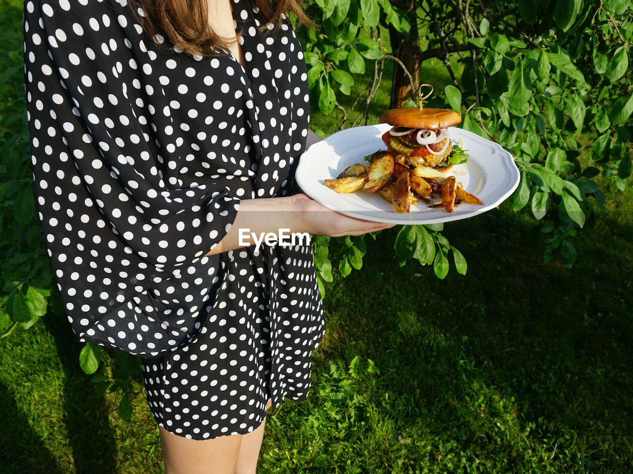 High angle view of woman holding food in plate