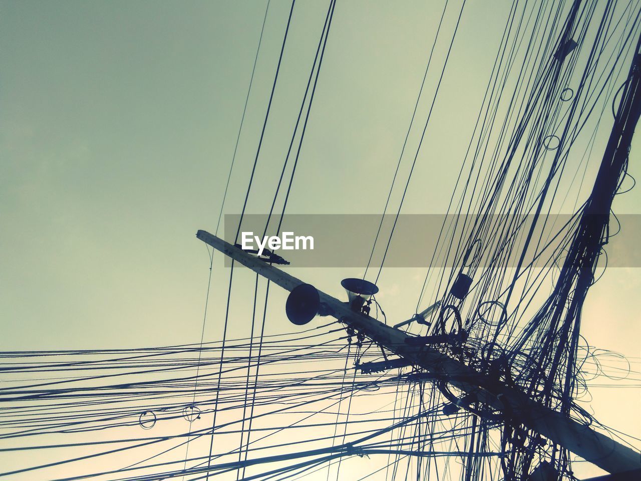 Low angle view of electricity pylon against sky