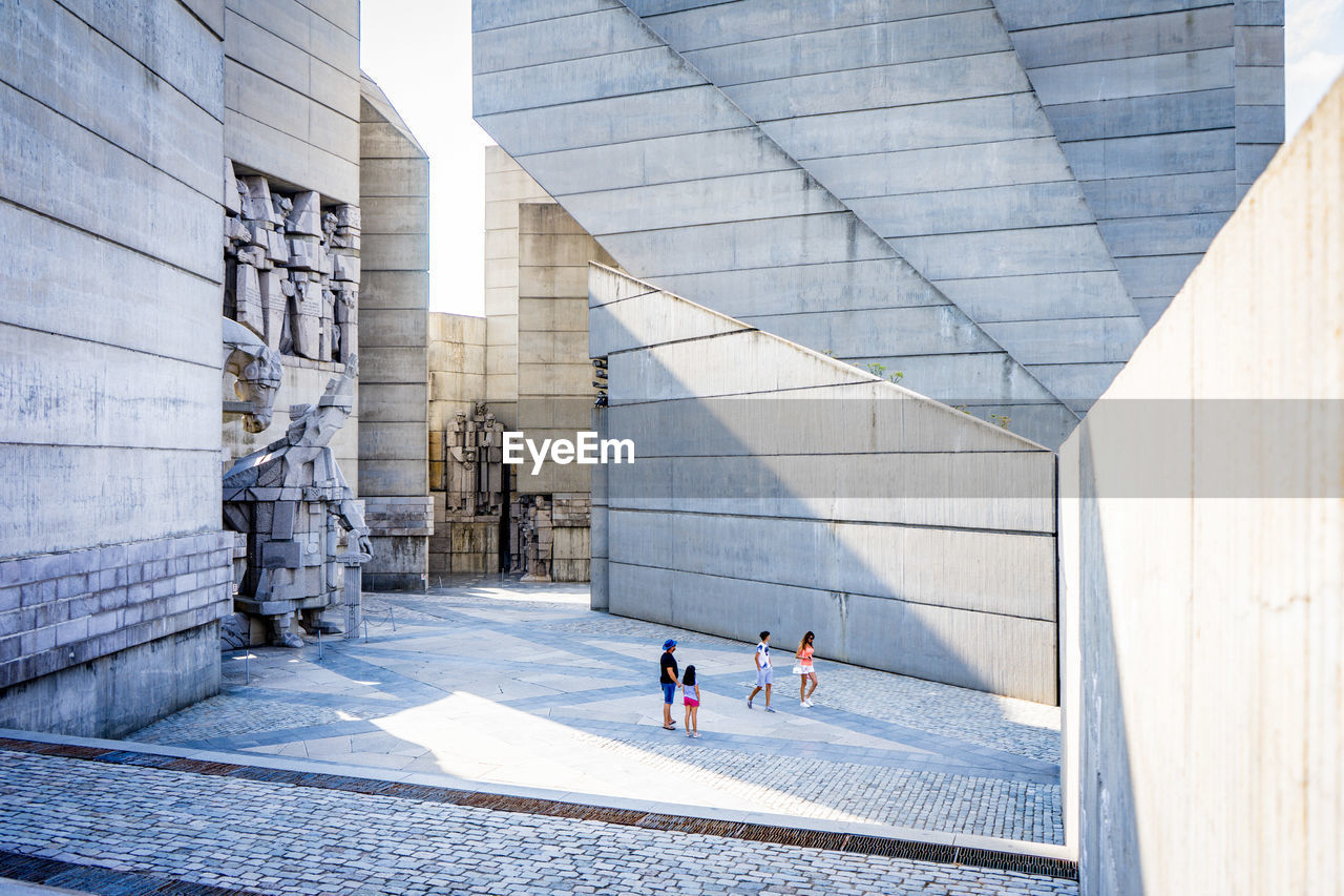 PEOPLE WALKING ON MODERN BUILDING