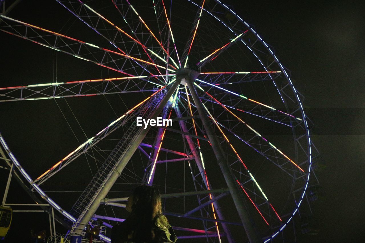 LOW ANGLE VIEW OF ILLUMINATED FERRIS WHEEL AGAINST SKY